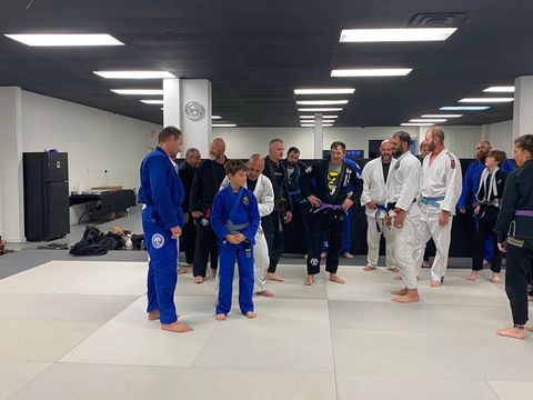 Students and coaches at a belt promotion night at Gustavo Machado BJJ Venice